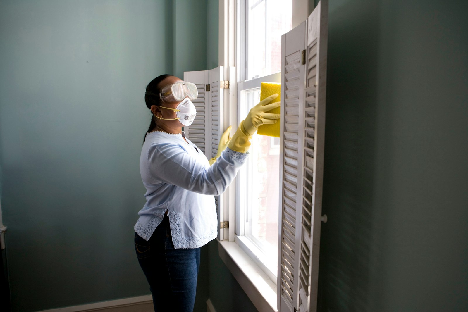 Painter rolling a wall